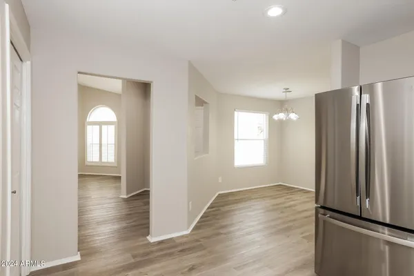 a view of empty room with wooden floor and window