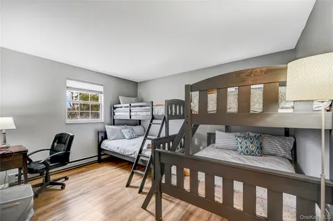 a bedroom with furniture and a wooden floor