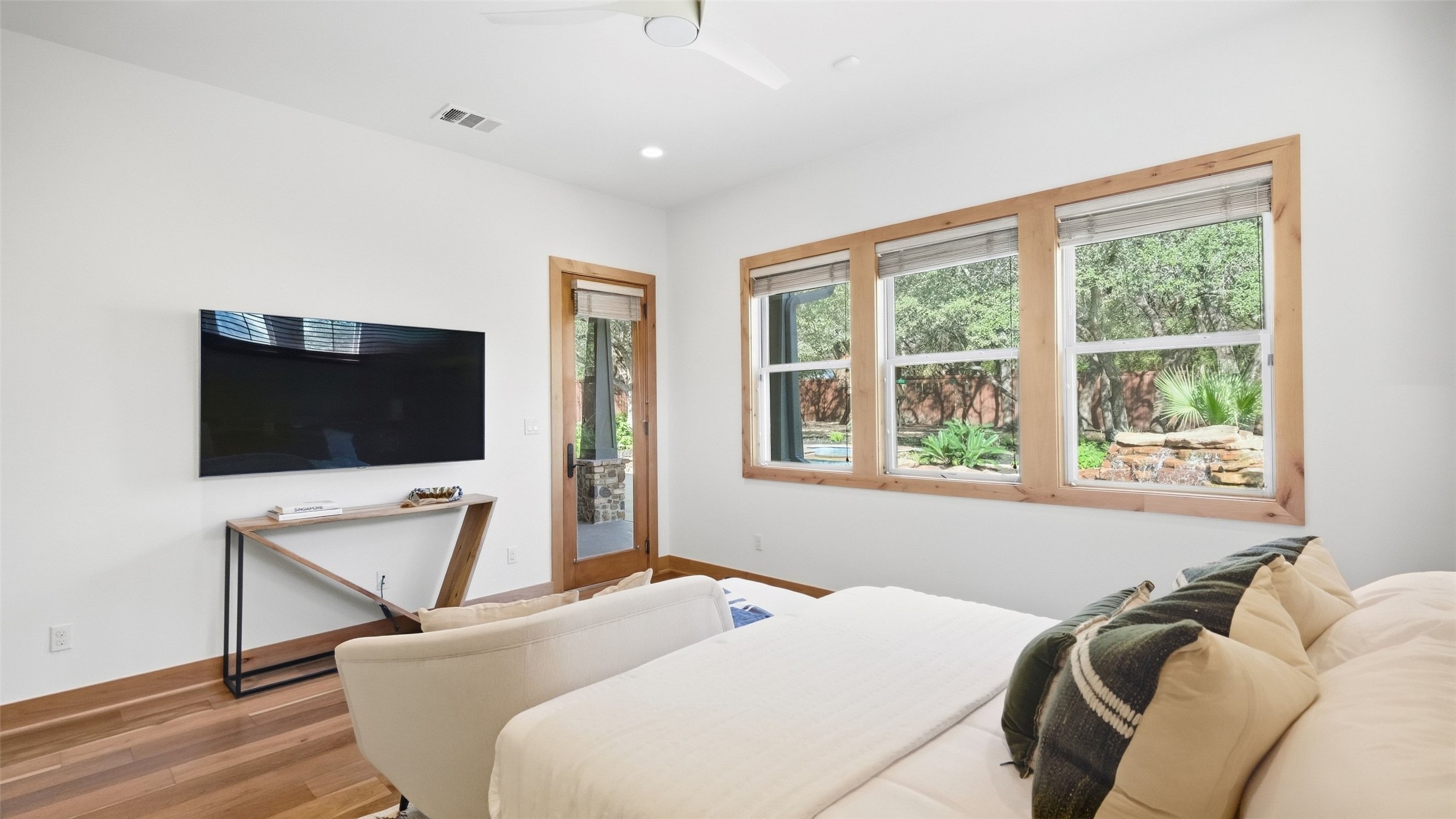 5910 Hudson Bend Road Austin, TX 78734 - Photo 24 of 40 Gleaming wood floors and timber-trimmed windows elevate this airy bedroom.