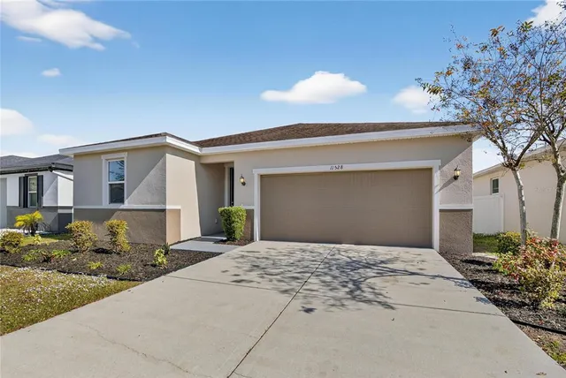 a front view of a house with a garden and patio