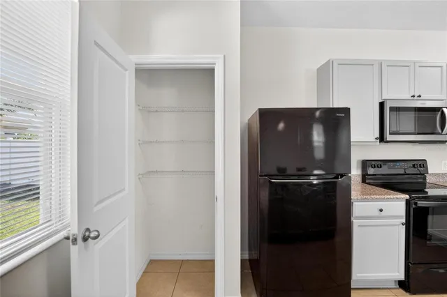 a kitchen with a refrigerator stove and microwave