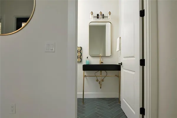 a bathroom with a toilet a sink and mirror