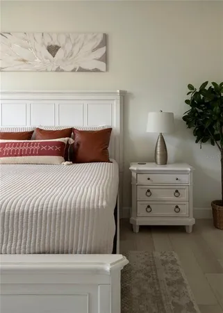 a bedroom with a bed and a lamp on table
