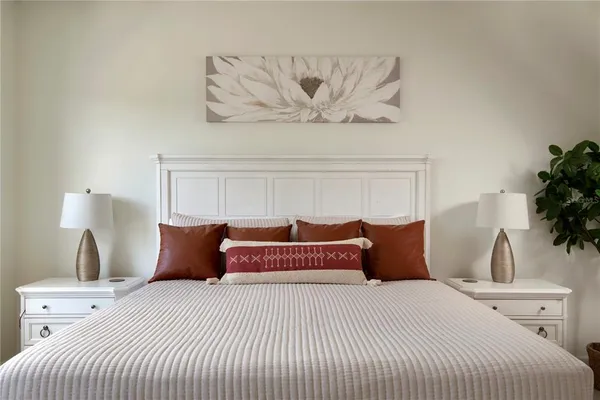 a bedroom with a bed and ceiling fan