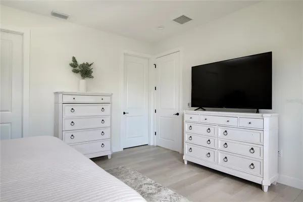 a bathroom with a sink double vanity granite tub shower and a mirror