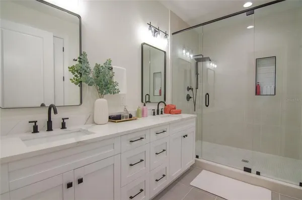 a en suite bathroom with double sink and a mirror