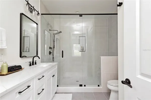 a white toilet sitting next to a bath tub shower
