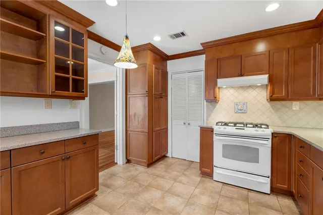 a kitchen with stainless steel appliances granite countertop a stove and a refrigerator