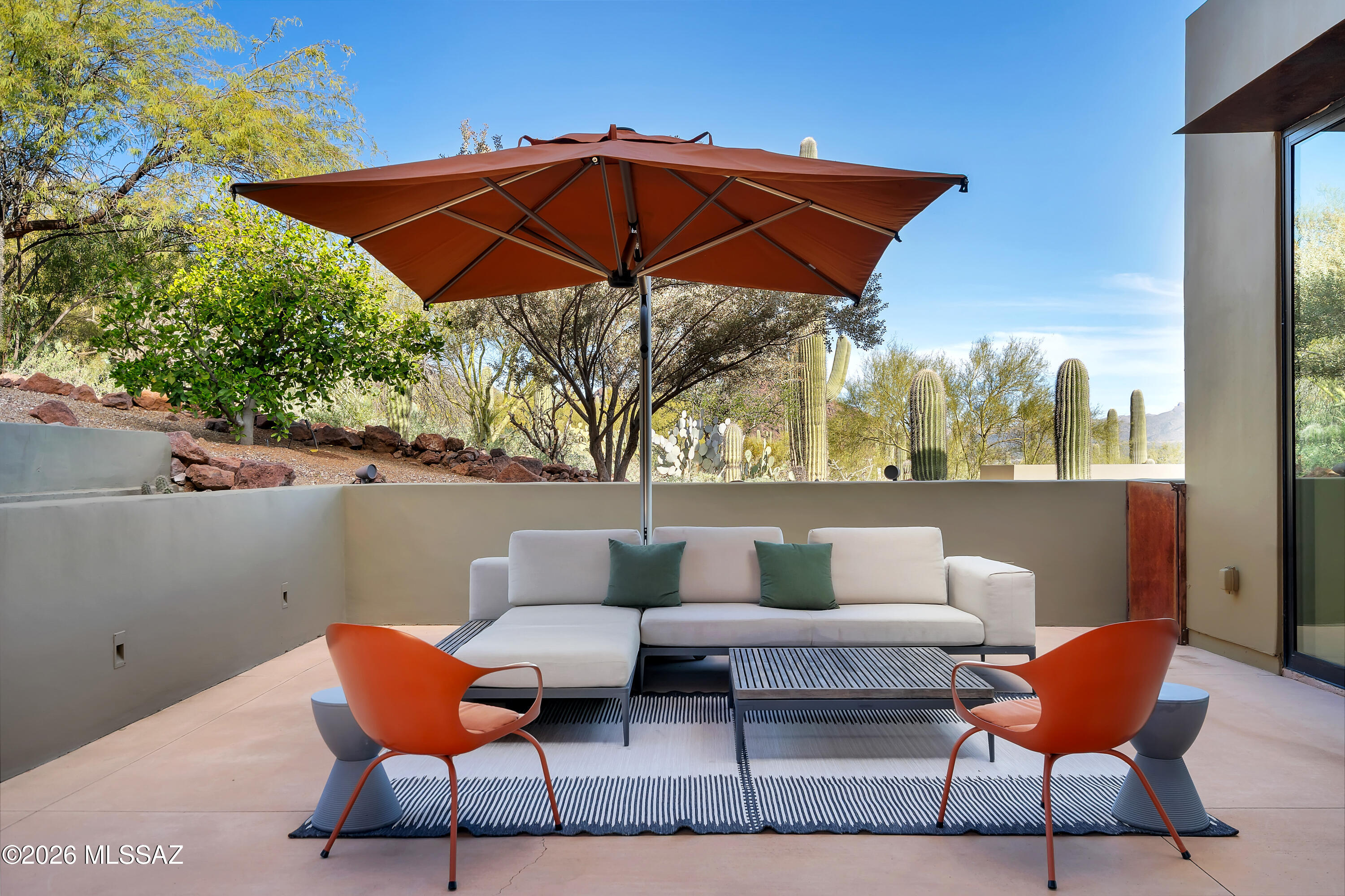 9971 North Silverbell Road Marana, AZ 85653 - Photo 29 of 34 a patio with a table and chairs under an umbrella