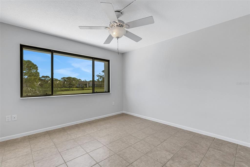 3119 Heatherwood Lane Sarasota, FL 34235 - Photo 13 of 47 an empty room with windows and fan