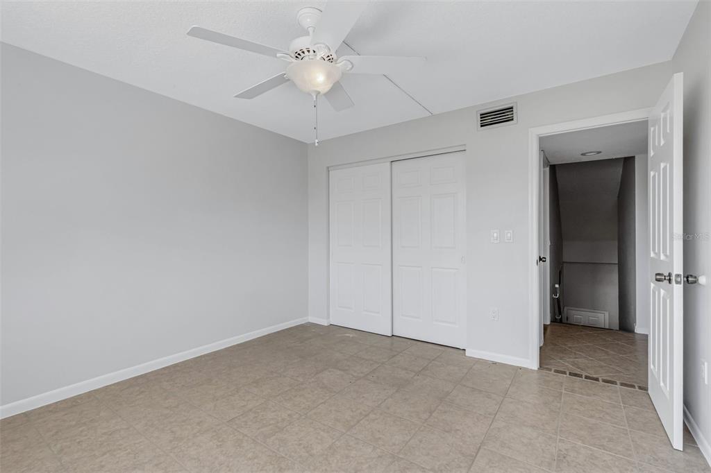 3119 Heatherwood Lane Sarasota, FL 34235 - Photo 16 of 47 an empty room with a ceiling fan and a fan