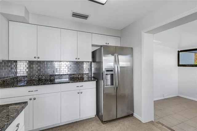 a kitchen with a sink window and cabinets