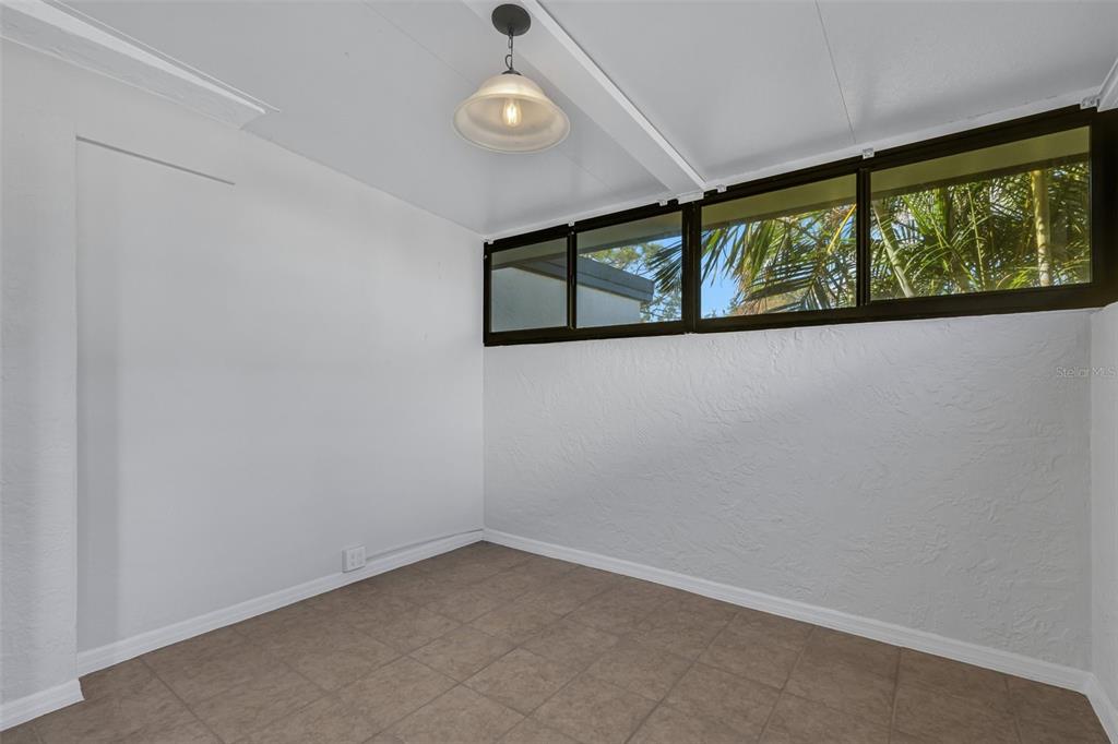 3119 Heatherwood Lane Sarasota, FL 34235 - Photo 42 of 47 an empty room with windows