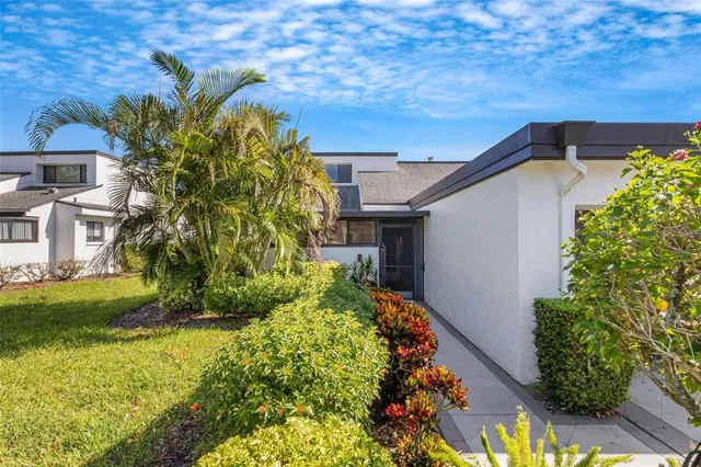 a view of a house with backyard and sitting area