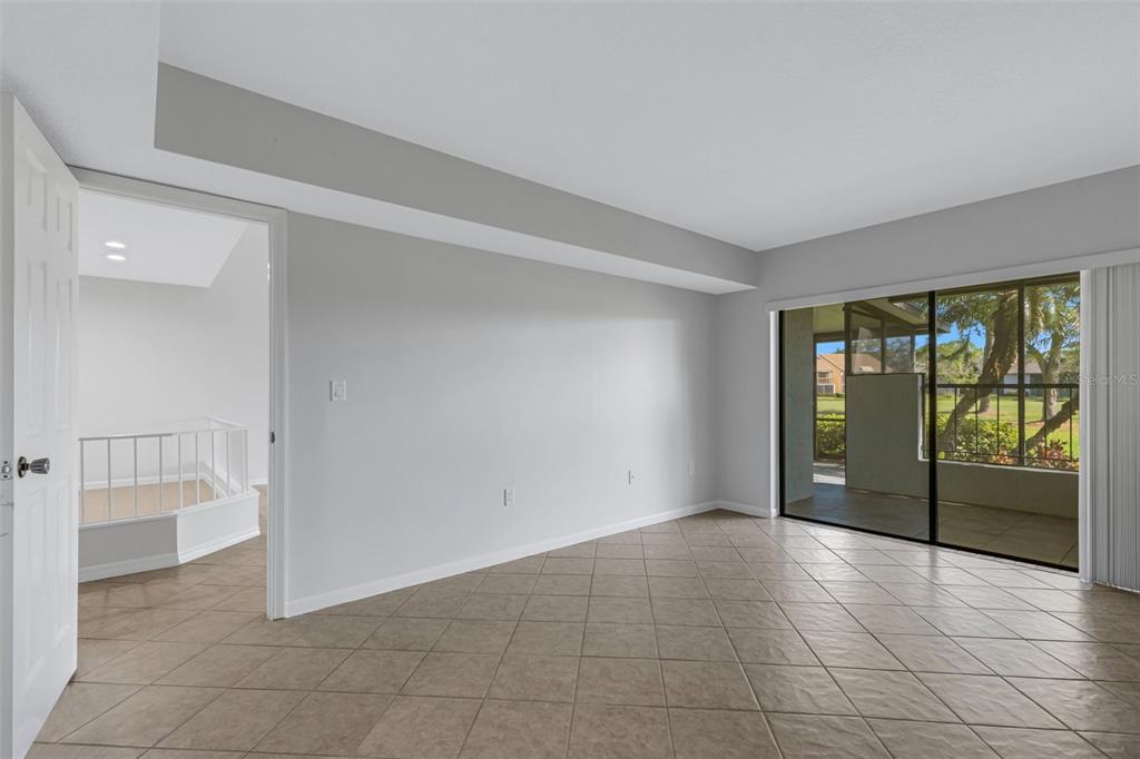 3119 Heatherwood Lane Sarasota, FL 34235 - Photo 7 of 47 a view of an empty room with glass door