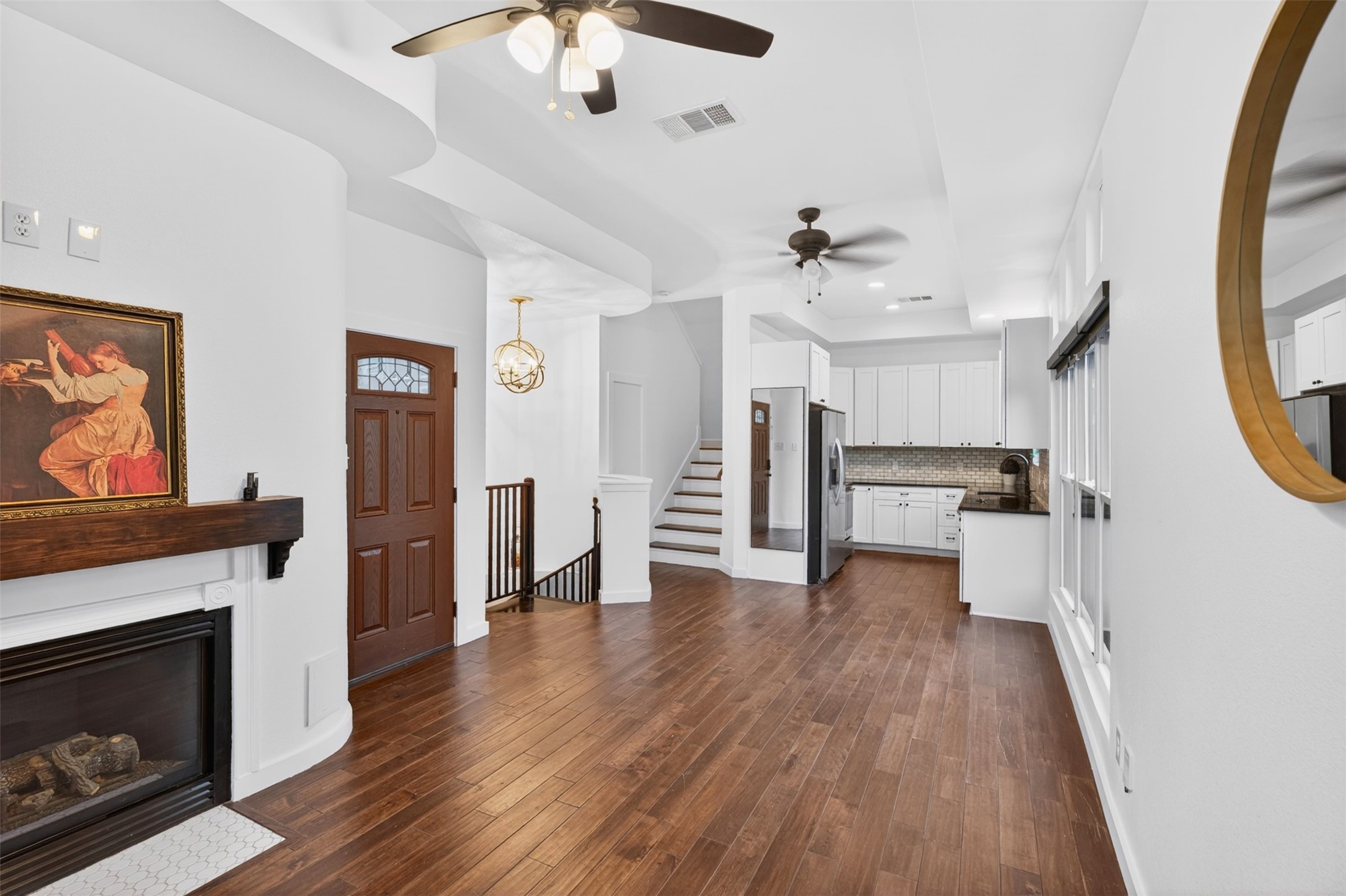 2716 Bagby Street Houston, TX 77006 - Photo 7 of 29 a view of a livingroom with wooden floor and a fireplace
