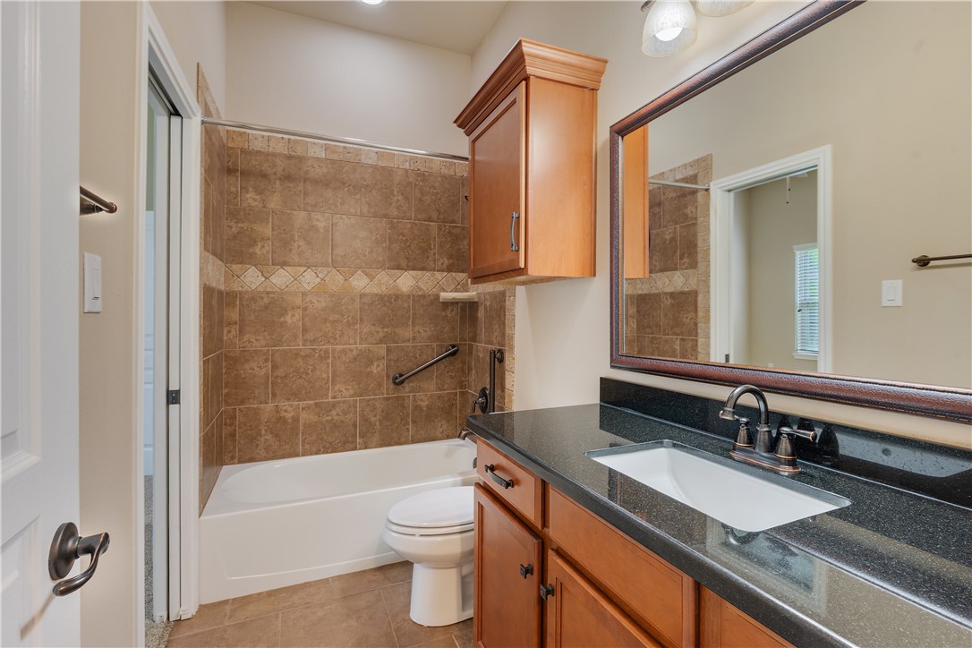 3085 Archer Circle Bryan, TX 77808 - Photo 17 of 31 a bathroom with a granite countertop sink toilet and shower