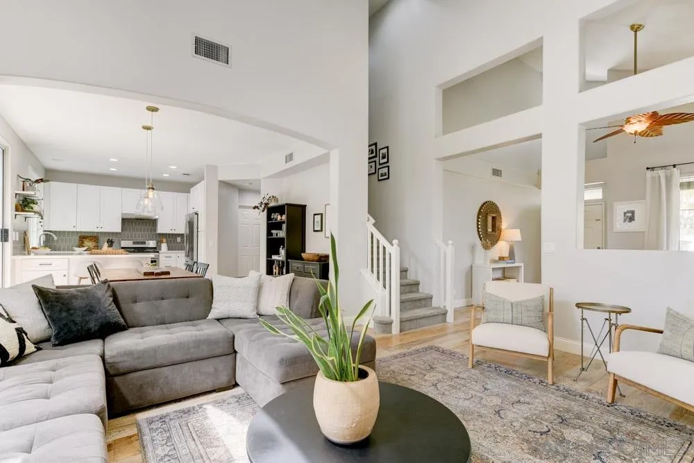 7730 Corte Marin Carlsbad, CA 92009 - Photo 1 of 26 a living room with furniture potted plant and kitchen view