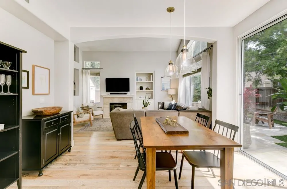 7730 Corte Marin Carlsbad, CA 92009 - Photo 11 of 26 a view of a dining room with furniture window and wooden floor