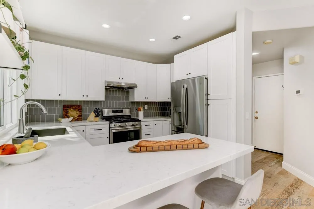 7730 Corte Marin Carlsbad, CA 92009 - Photo 12 of 26 a kitchen with stainless steel appliances a refrigerator sink and stove