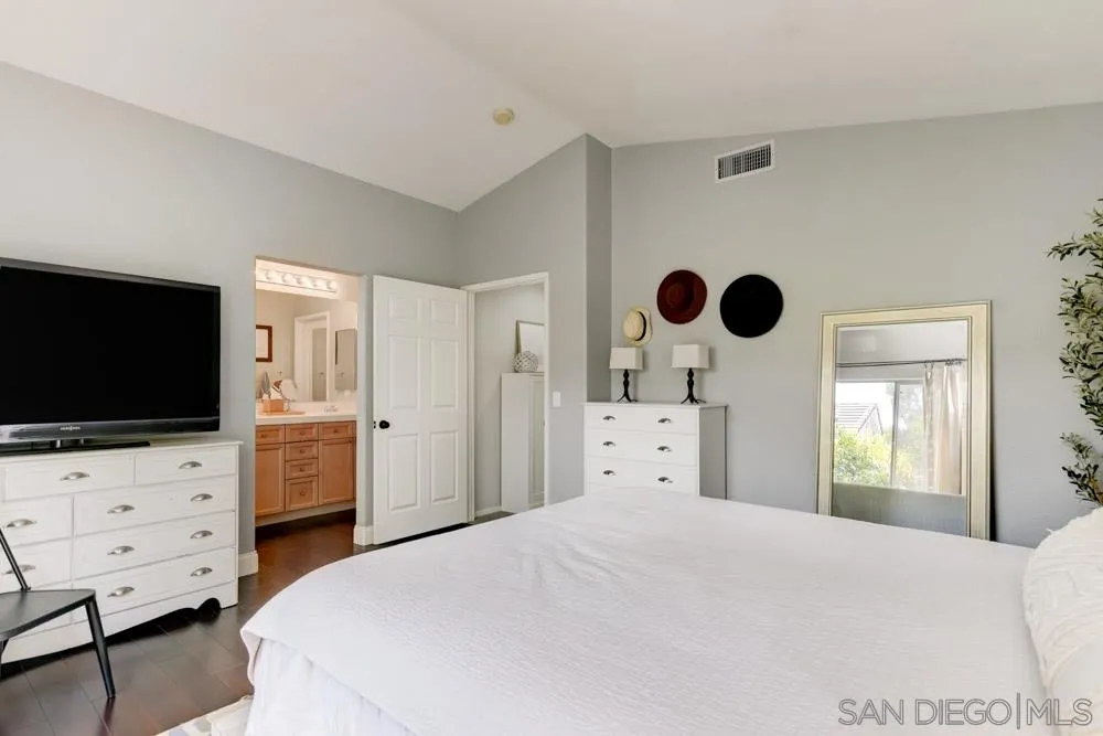 7730 Corte Marin Carlsbad, CA 92009 - Photo 15 of 26 a bedroom with furniture and flat screen tv