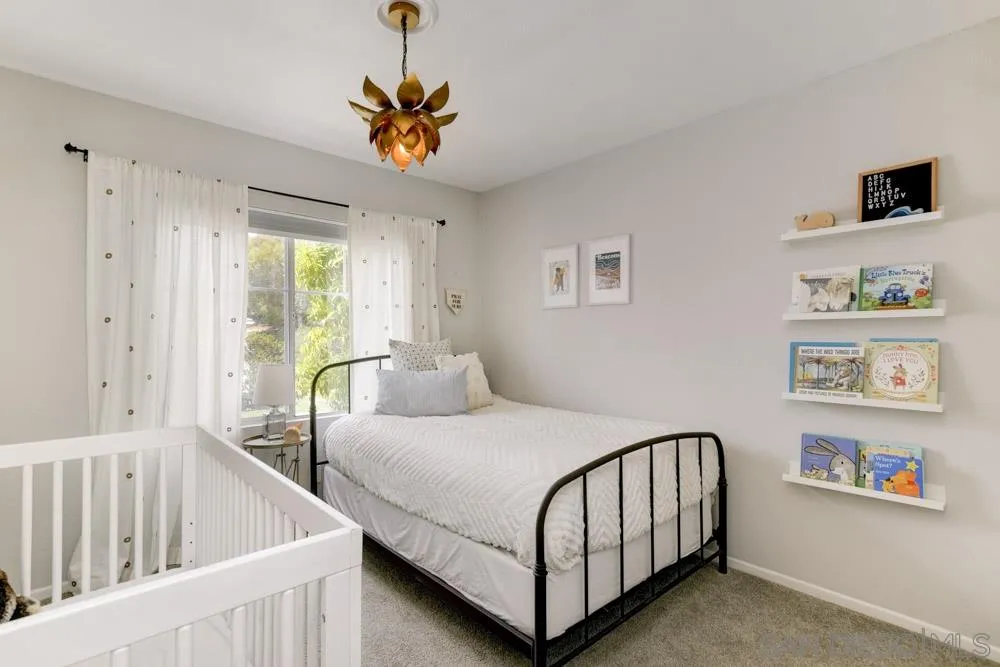 7730 Corte Marin Carlsbad, CA 92009 - Photo 17 of 26 a bedroom with furniture and a window