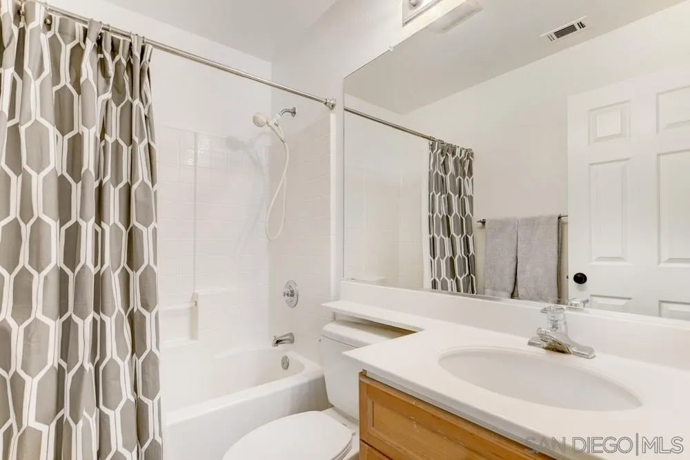 7730 Corte Marin Carlsbad, CA 92009 - Photo 19 of 26 a bathroom with a sink and a mirror