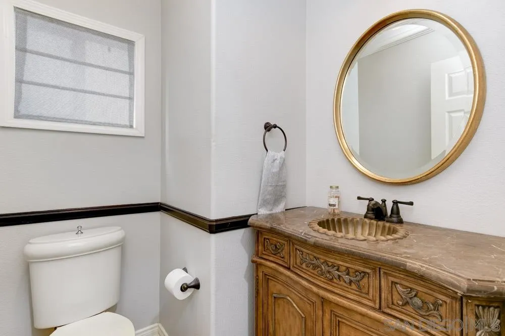 7730 Corte Marin Carlsbad, CA 92009 - Photo 20 of 26 a bathroom with a granite countertop sink and a mirror