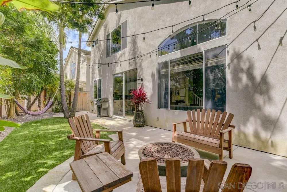 7730 Corte Marin Carlsbad, CA 92009 - Photo 23 of 26 a view of a patio with couches table and chairs and potted plants