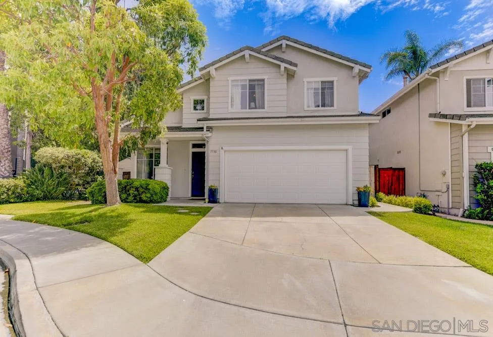 7730 Corte Marin Carlsbad, CA 92009 - Photo 5 of 26 a front view of a house with a yard and garage