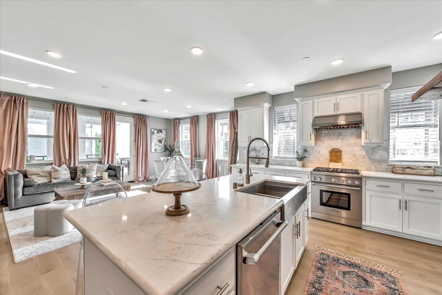 1512 Bond Street Milpitas, CA 95035 - Photo 14 of 49 a kitchen with stainless steel appliances granite countertop a sink stove and refrigerator