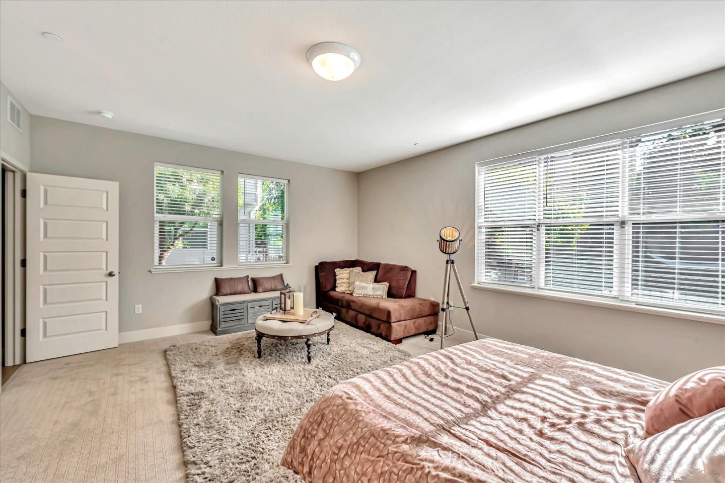 1512 Bond Street Milpitas, CA 95035 - Photo 24 of 49 a bedroom with a bed and large windows