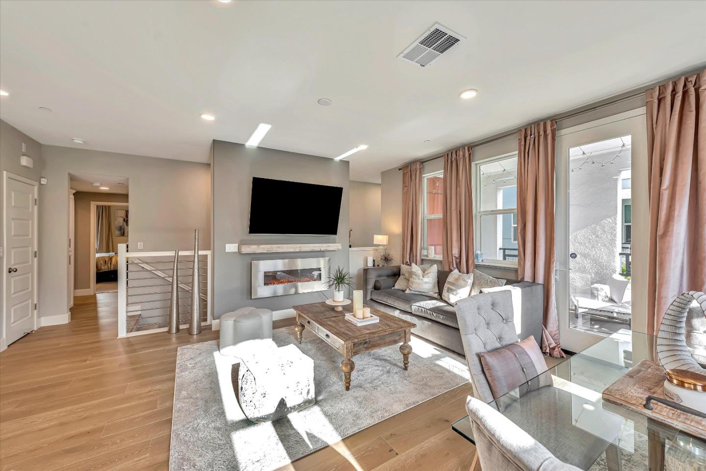 1512 Bond Street Milpitas, CA 95035 - Photo 6 of 49 a living room with furniture a flat screen tv and a floor to ceiling window