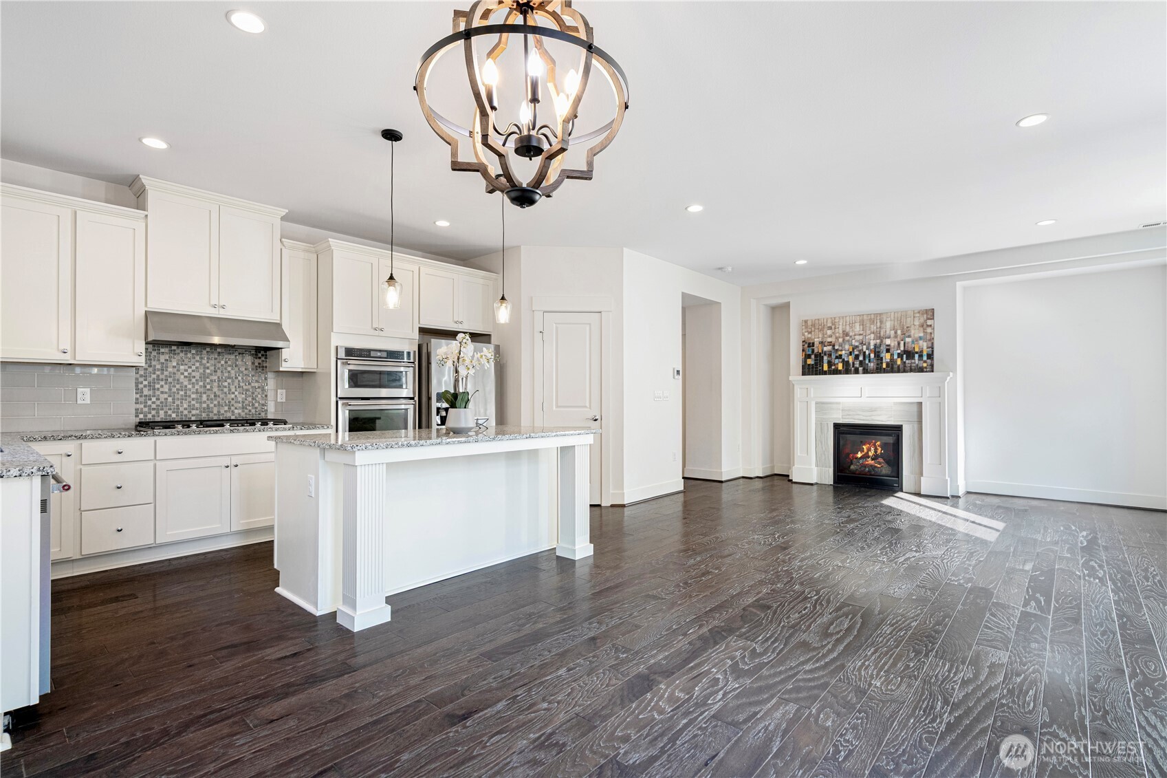 18717 43rd Drive Southeast Bothell, WA 98012 - Photo 10 of 26 a kitchen with stainless steel appliances granite countertop a refrigerator a stove a oven and white cabinets with wooden floor