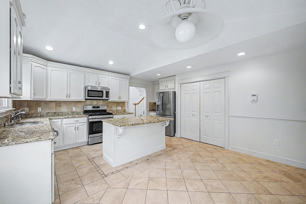 3 Oak View Terrace, Unit 3 Franklin, MA 02038 - Photo 9 of 38 a kitchen with white cabinets a sink stove and refrigerator