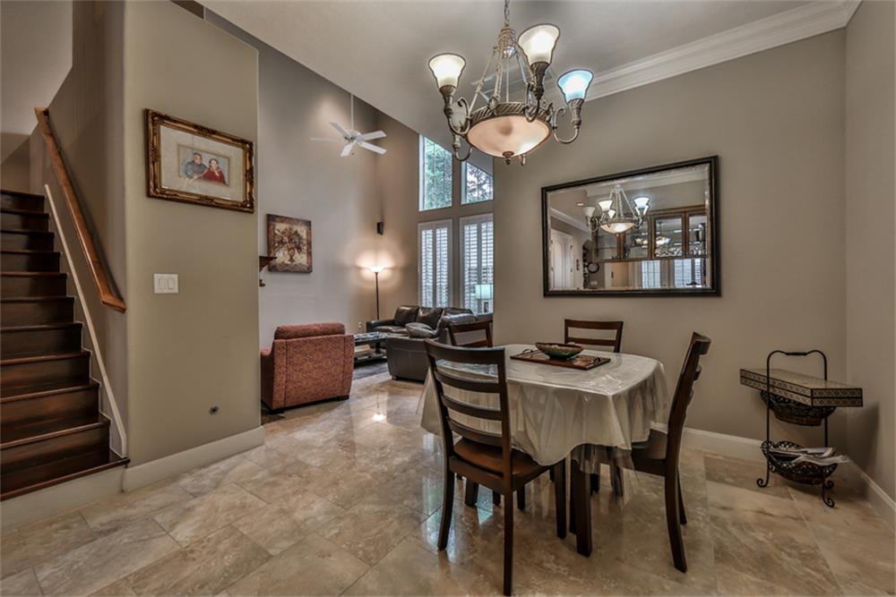 1005 Memorial Village Drive Houston, TX 77024 - Photo 12 of 32 a view of a dining room with furniture and chandelier