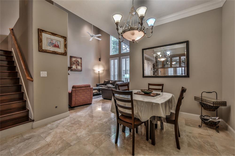 1005 Memorial Village Drive Houston, TX 77024 - Photo 13 of 32 a view of a dining room with furniture and chandelier