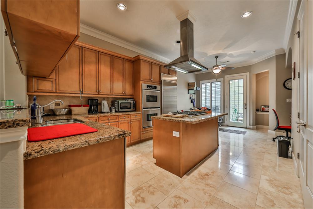 1005 Memorial Village Drive Houston, TX 77024 - Photo 14 of 32 a kitchen with stainless steel appliances granite countertop sink stove and cabinets