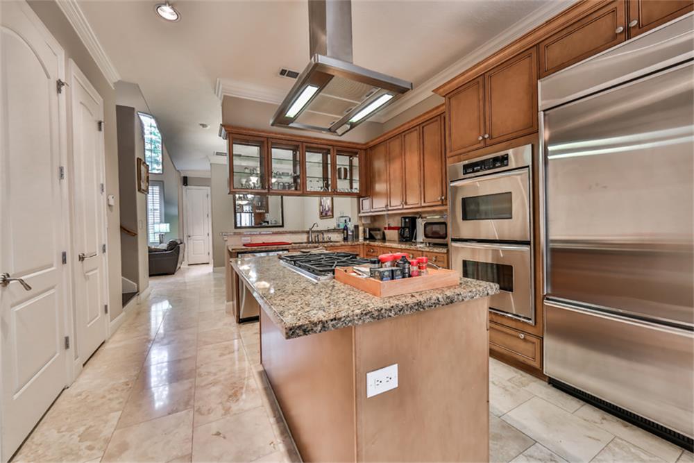 1005 Memorial Village Drive Houston, TX 77024 - Photo 15 of 32 a kitchen with stainless steel appliances granite countertop a sink stove and refrigerator