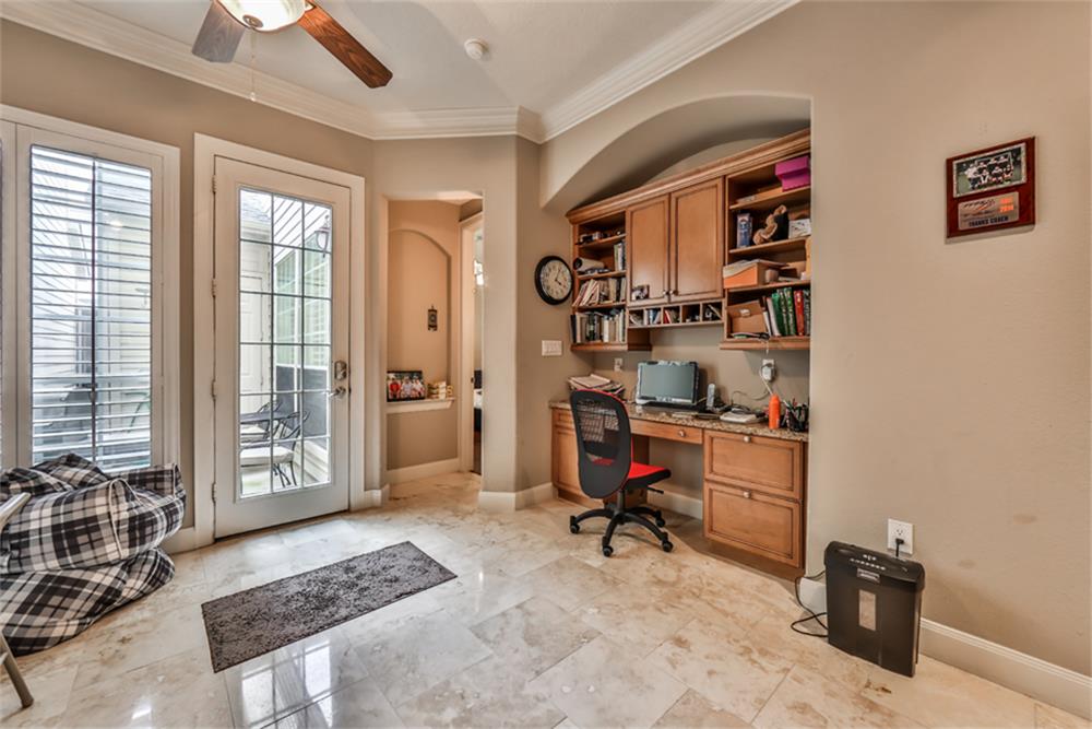 1005 Memorial Village Drive Houston, TX 77024 - Photo 17 of 32 a view of a workspace with furniture and a window