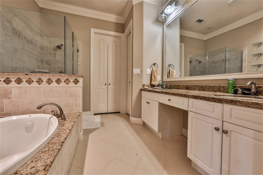 1005 Memorial Village Drive Houston, TX 77024 - Photo 22 of 32 a spacious bathroom with a tub sink and mirror
