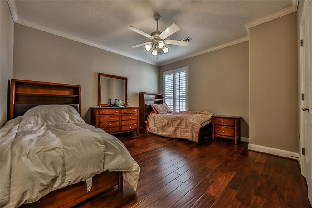 1005 Memorial Village Drive Houston, TX 77024 - Photo 25 of 32 a bedroom with two beds and a chandelier