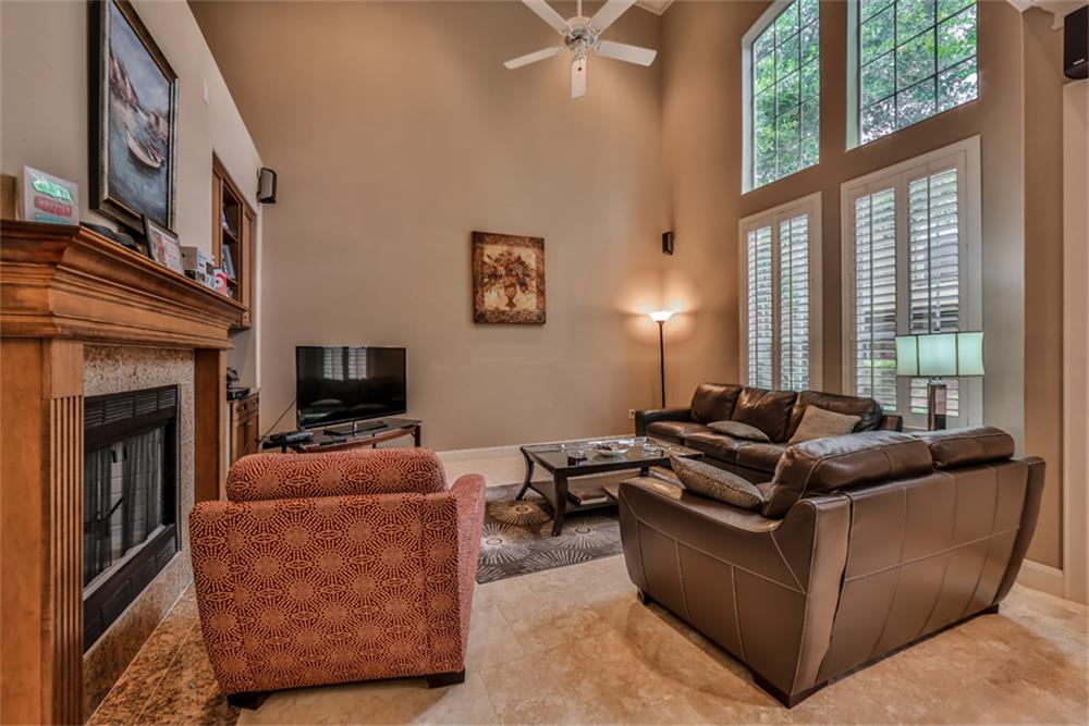 1005 Memorial Village Drive Houston, TX 77024 - Photo 7 of 32 a living room with furniture a large window and a fireplace