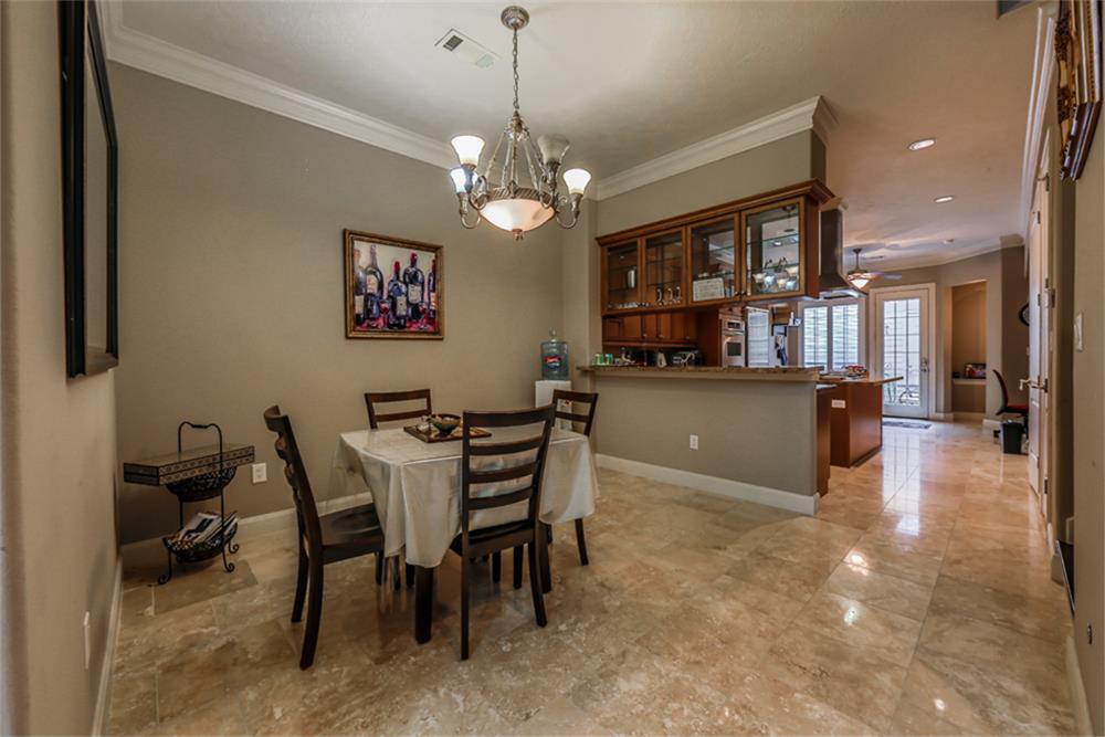 1005 Memorial Village Drive Houston, TX 77024 - Photo 9 of 32 a view of a dining room with furniture and a chandelier