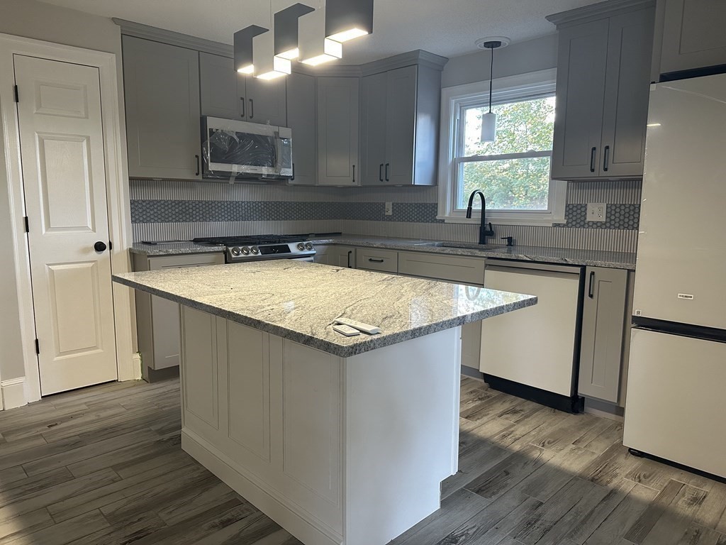 144 Stony Hill Road Wilbraham, MA 01095 - Photo 4 of 15 a kitchen with a sink and a refrigerator