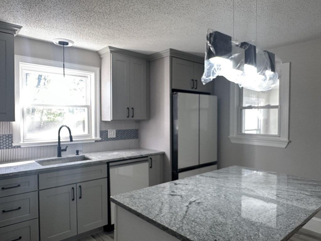 144 Stony Hill Road Wilbraham, MA 01095 - Photo 6 of 15 a kitchen with sink cabinets and window