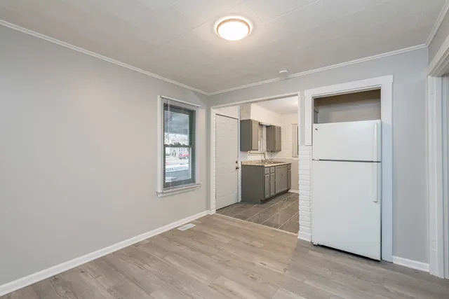 a view of a kitchen with a sink dishwasher and a refrigerator
