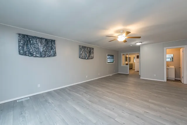 wooden floor in an empty room with a window