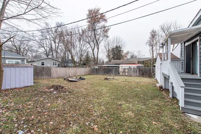a view of a yard with a house and a tree
