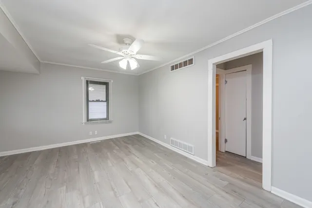 wooden floor in an empty room with a window